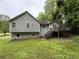 Charming split-level home featuring a deck in a lush green backyard, perfect for outdoor relaxation at 2326 Westland Way, Acworth, GA 30102