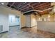 Unfinished basement with exposed ceiling, hanging lights and interior doorway at 2326 Westland Way, Acworth, GA 30102