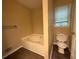 Bathroom featuring a tub, toilet, and hardwood floors at 2326 Westland Way, Acworth, GA 30102