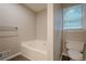 Bright bathroom with soaking tub, modern toilet, and natural light from window at 2326 Westland Way, Acworth, GA 30102
