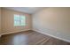 This bedroom has neutral walls, a window letting in ample light, and laminate flooring at 2326 Westland Way, Acworth, GA 30102