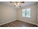This bedroom has a ceiling fan, a window letting in ample light, and laminate flooring at 2326 Westland Way, Acworth, GA 30102