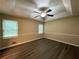Large bedroom with hardwood floors, neutral paint, and a tray ceiling at 2326 Westland Way, Acworth, GA 30102