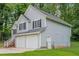Exterior view showcasing the home's siding, windows with shutters, two-car garage, and a fenced yard at 2326 Westland Way, Acworth, GA 30102