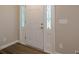 Bright foyer featuring a white front door with decorative glass, leading to the home's interior at 2326 Westland Way, Acworth, GA 30102