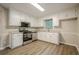 Well-lit kitchen features white cabinets and stainless steel appliances at 2326 Westland Way, Acworth, GA 30102