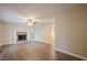 Inviting living room with a cozy stone fireplace, hardwood floors, and natural light from large windows at 2326 Westland Way, Acworth, GA 30102