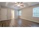 Spacious main bedroom with a ceiling fan, laminate flooring and two windows at 2326 Westland Way, Acworth, GA 30102