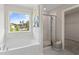 Bright bathroom featuring a large window over tub and glass enclosed shower at 286 Abbotts Crossing Cir, Conyers, GA 30094