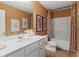 Neutral bathroom with shower-tub combo, framed art, and ample counter space at 286 Abbotts Crossing Cir, Conyers, GA 30094