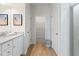 Bright bathroom with dual sinks, white cabinetry, and a glass-enclosed shower at 286 Abbotts Crossing Cir, Conyers, GA 30094