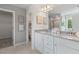 Bright bathroom features a double vanity with granite countertop and decorative wall art at 286 Abbotts Crossing Cir, Conyers, GA 30094