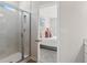 Bathroom showcasing tiled shower with glass and open doorway to the bedroom at 286 Abbotts Crossing Cir, Conyers, GA 30094