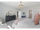 Spacious primary bedroom with decorative light fixture and views of the outdoors at 286 Abbotts Crossing Cir, Conyers, GA 30094
