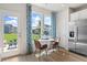 Bright breakfast nook features a charming table, backyard access, and stainless refrigerator at 286 Abbotts Crossing Cir, Conyers, GA 30094