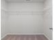 Spacious walk-in closet with carpet flooring and wire shelving at 286 Abbotts Crossing Cir, Conyers, GA 30094