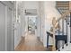 Bright entryway featuring wood floors, staircase with black iron railings, and open access to the kitchen at 286 Abbotts Crossing Cir, Conyers, GA 30094