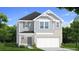 Charming two-story home featuring stone accents, gray siding, manicured lawn and a two-car garage at 286 Abbotts Crossing Cir, Conyers, GA 30094