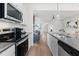 Galley kitchen design overlooking living area with stainless appliances and sleek countertops at 286 Abbotts Crossing Cir, Conyers, GA 30094