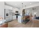 Open kitchen flows to the living area with stainless appliances and an island with bar seating at 286 Abbotts Crossing Cir, Conyers, GA 30094