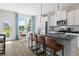 Bright kitchen featuring stainless steel appliances, island with seating, and convenient backyard access at 286 Abbotts Crossing Cir, Conyers, GA 30094