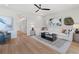 Bright living room with wood floors, contemporary furniture, stylish decor, and seamless flow to other spaces at 286 Abbotts Crossing Cir, Conyers, GA 30094