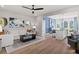 Open-concept living room with wood floors, modern decor, and seamless transition to the kitchen at 286 Abbotts Crossing Cir, Conyers, GA 30094