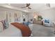 Spacious main bedroom featuring carpeted floors, tray ceilings, and ample natural light at 286 Abbotts Crossing Cir, Conyers, GA 30094