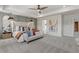 Main bedroom with tray ceiling, neutral tones, and accent wall at 286 Abbotts Crossing Cir, Conyers, GA 30094