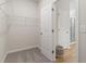 Spacious walk-in closet featuring carpeted floor, shelving and two door access at 286 Abbotts Crossing Cir, Conyers, GA 30094