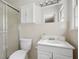 Bright bathroom featuring a glass-enclosed shower, toilet, and vanity with sink at 4527 Sims Ct, Tucker, GA 30084