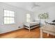 Well-lit bedroom with hardwood floors, two windows, and a ceiling fan at 4527 Sims Ct, Tucker, GA 30084