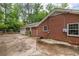 Brick home exterior with attached garage, surrounded by mature trees and landscaping at 4527 Sims Ct, Tucker, GA 30084