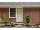 Charming brick home featuring a lovely entrance with potted plants adding a touch of greenery and curb appeal at 4527 Sims Ct, Tucker, GA 30084