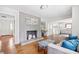 Open concept living room with a brick fireplace, hardwood floors, and an open concept to kitchen at 4527 Sims Ct, Tucker, GA 30084