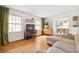 Living room with hardwood floors, natural light, and open concept to dining area at 4527 Sims Ct, Tucker, GA 30084