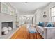 Open living room with hardwood floors, a fireplace, and an open concept to kitchen at 4527 Sims Ct, Tucker, GA 30084