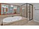 Beautiful bathroom featuring a jacuzzi tub and tiled walk-in shower at 5407 Waters Edge Trl, Roswell, GA 30075