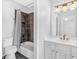 Bathroom featuring modern fixtures and a shower-tub combo at 5407 Waters Edge Trl, Roswell, GA 30075