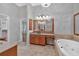 Inviting primary bathroom featuring a jacuzzi tub and granite countertops at 5407 Waters Edge Trl, Roswell, GA 30075