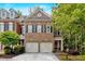 Charming brick home with a two-car garage and manicured landscaping at 5407 Waters Edge Trl, Roswell, GA 30075