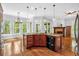 Open concept kitchen featuring an island with dark wood cabinets, granite countertops and views to the living area at 5407 Waters Edge Trl, Roswell, GA 30075