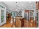 Spacious kitchen boasts an island with granite countertops, stainless steel appliances, and hardwood floors at 5407 Waters Edge Trl, Roswell, GA 30075