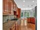 Gourmet kitchen featuring granite countertops, stainless steel appliances, tile backsplash, and view to the breakfast nook at 5407 Waters Edge Trl, Roswell, GA 30075
