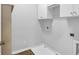 Laundry room offers plenty of storage with white cabinets at 5407 Waters Edge Trl, Roswell, GA 30075