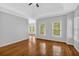 Open living room with hardwood floors, neutral paint and tray ceiling at 5407 Waters Edge Trl, Roswell, GA 30075