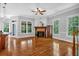 Bright living room with hardwood floors, fireplace and view of the backyard at 5407 Waters Edge Trl, Roswell, GA 30075