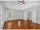 Large main bedroom featuring hardwood floors, tray ceiling and staircase access at 5407 Waters Edge Trl, Roswell, GA 30075