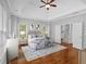 Comfortable main bedroom with hardwood floors, tray ceiling and staircase access at 5407 Waters Edge Trl, Roswell, GA 30075