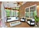 Inviting covered patio featuring stylish outdoor furniture, a modern fire pit, and a serene view of the wooded backyard at 5407 Waters Edge Trl, Roswell, GA 30075